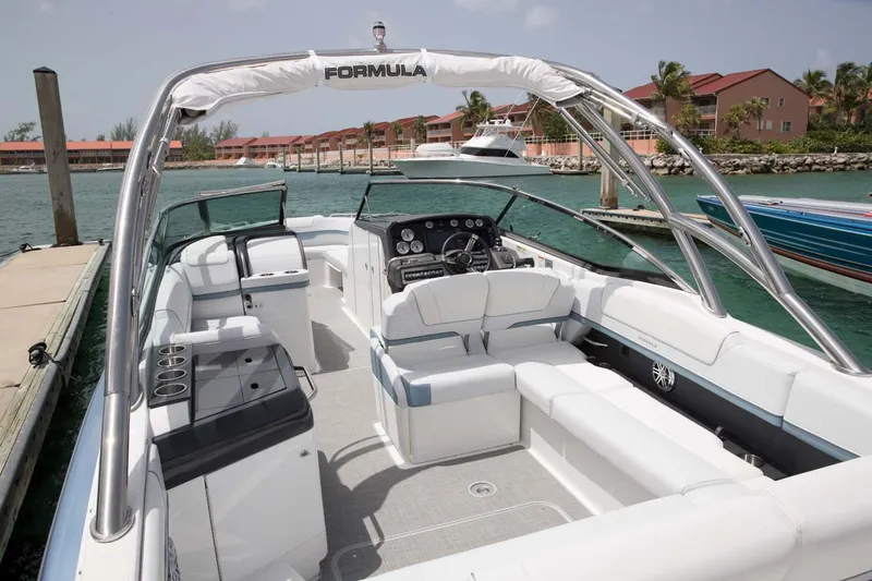 Slide: The Image of Manufacturer Provided Image: 2021 Formula 310 Bowrider OB boat docked at a marina with luxurious seating. - 8