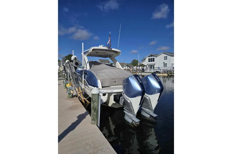Slide: The Image of 2020 Formula 310 Bowrider OB docked with twin outboard engines, clear sky background. - 19