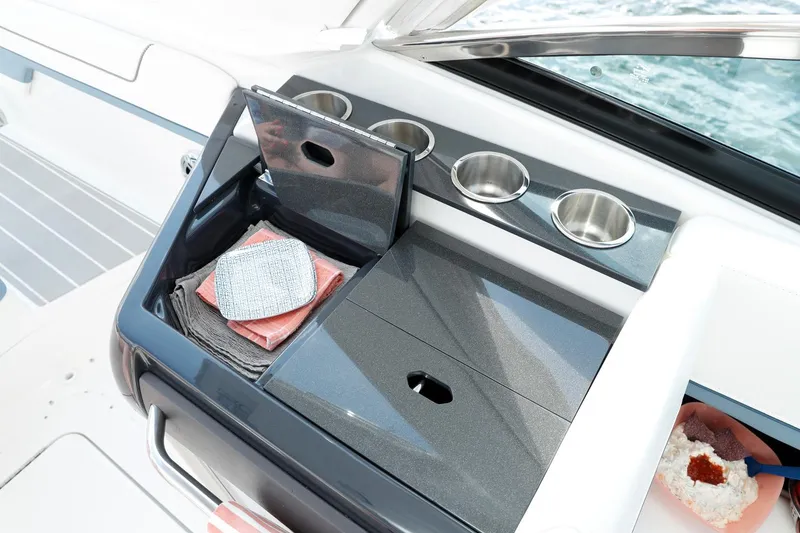 Slide: The Image of Manufacturer Provided Image: 2021 Formula 310 Bowrider OB boat interior with storage compartment and cup holders. - 10