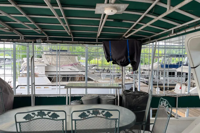 Slide: The Image of Covered deck of a 1997 Lakeview 65x18 houseboat with marina view. - 19