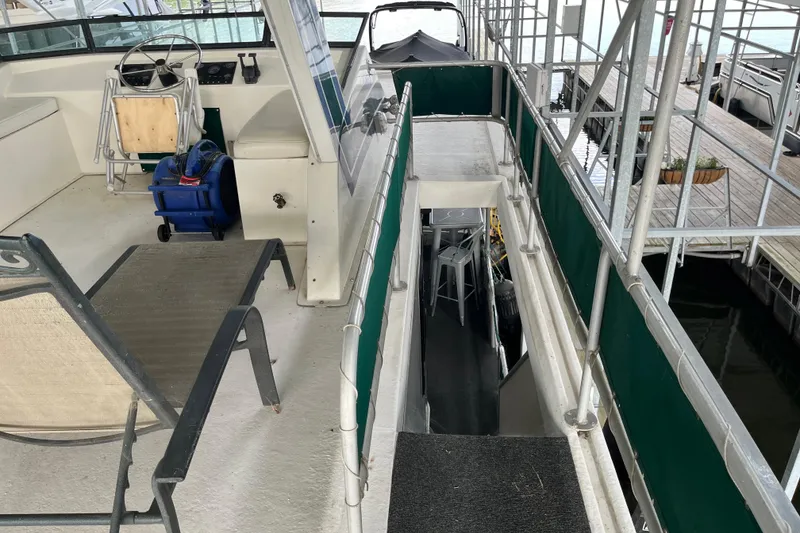 Slide: The Image of Upper deck of a 1997 Lakeview 65x18 houseboat with seating and helm. - 20