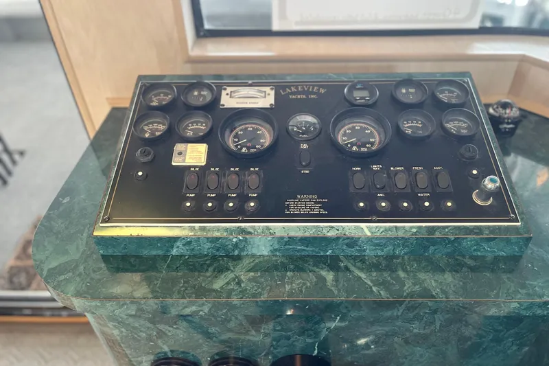 Slide: The Image of Control panel of a 1997 Lakeview 65x18 yacht with gauges and switches. - 32