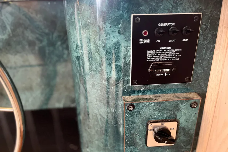Slide: The Image of Control panel of a 1997 Lakeview 65x18 generator with warning label and hour meter. - 28