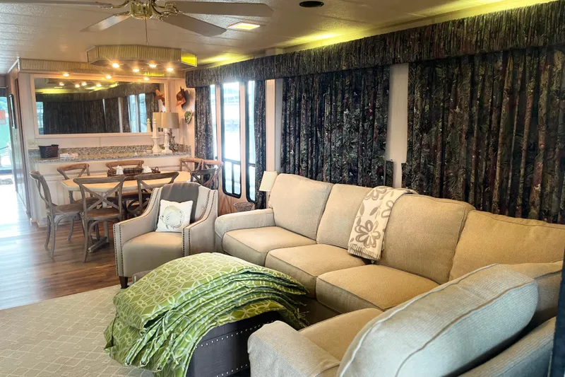 Slide: The Image of Cozy living area in a 1997 Lakeview 65x18 houseboat with elegant furnishings and decor. - 5