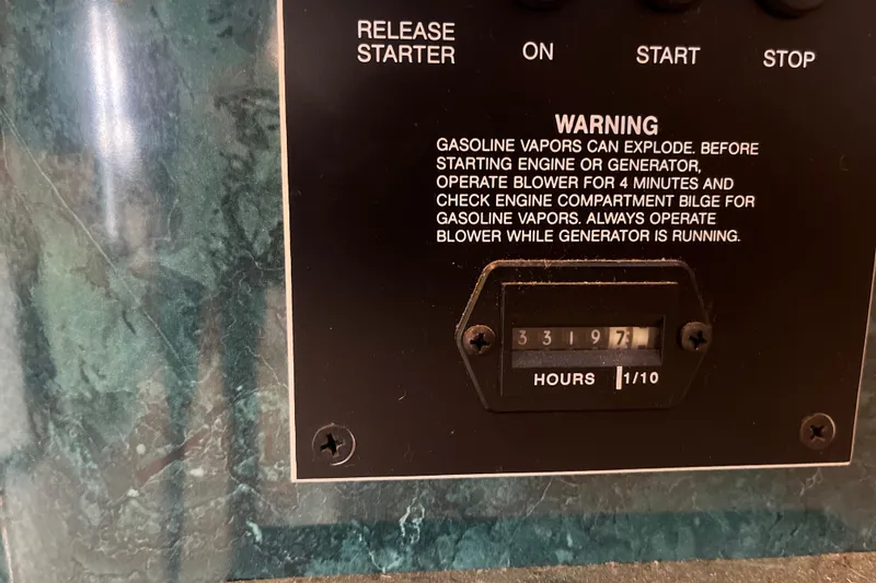 Slide: The Image of Control panel with warning label and hour meter reading 3319.7 hours on Lakeview 65x18, 1997 model. - 29