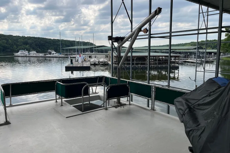 Slide: The Image of Houseboat docked at marina with scenic lake view, Lakeview 65x18, 1997 model. - 24