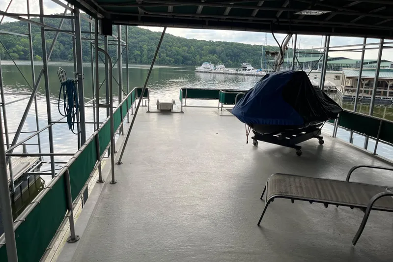 Slide: The Image of Covered deck of a 1997 Lakeview 65x18 houseboat with scenic lake view. - 23