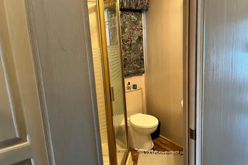 Slide: The Image of Compact bathroom in a 1997 Lakeview 65x18 houseboat with shower and toilet. - 12