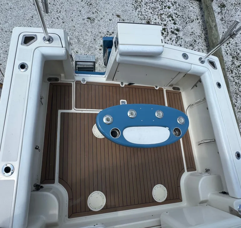 Slide: The Image of The image shows the cockpit of a 2002 Pursuit 3000 Express boat with wood flooring and a fishing station. - 17