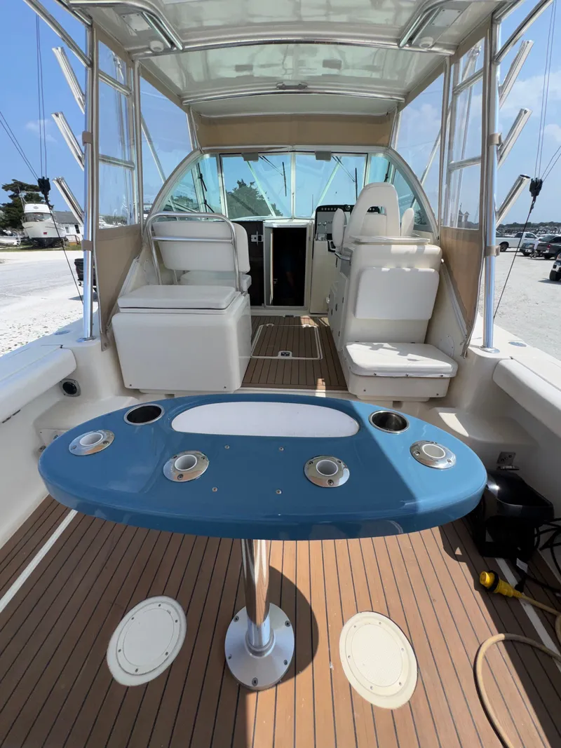 Slide: The Image of The image shows the cockpit of a 2002 Pursuit 3000 Express with a blue table. - 15