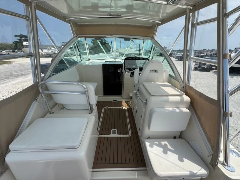 Slide: The Image of Interior of a 2002 Pursuit 3000 Express with seating and helm station. - 11