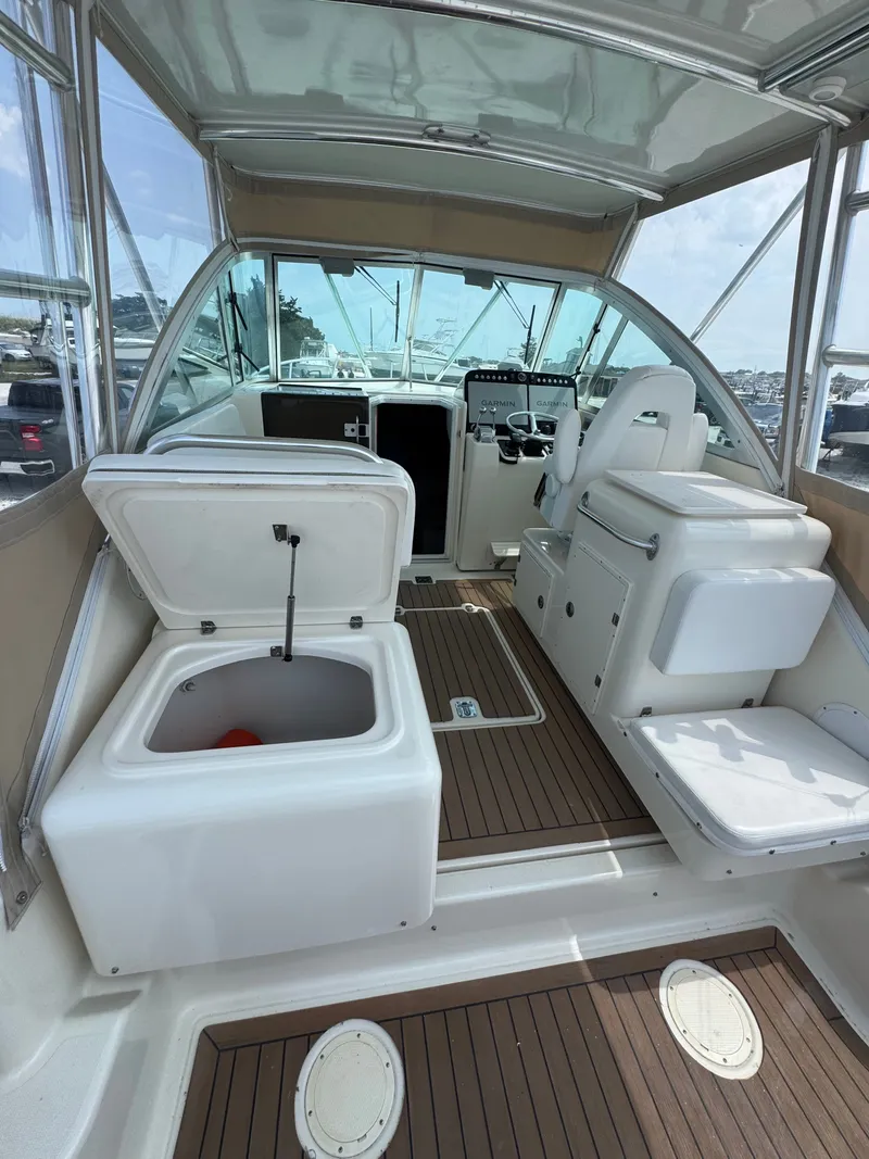 Slide: The Image of The image shows the cockpit of a 2002 Pursuit 3000 Express with an open storage compartment. - 12