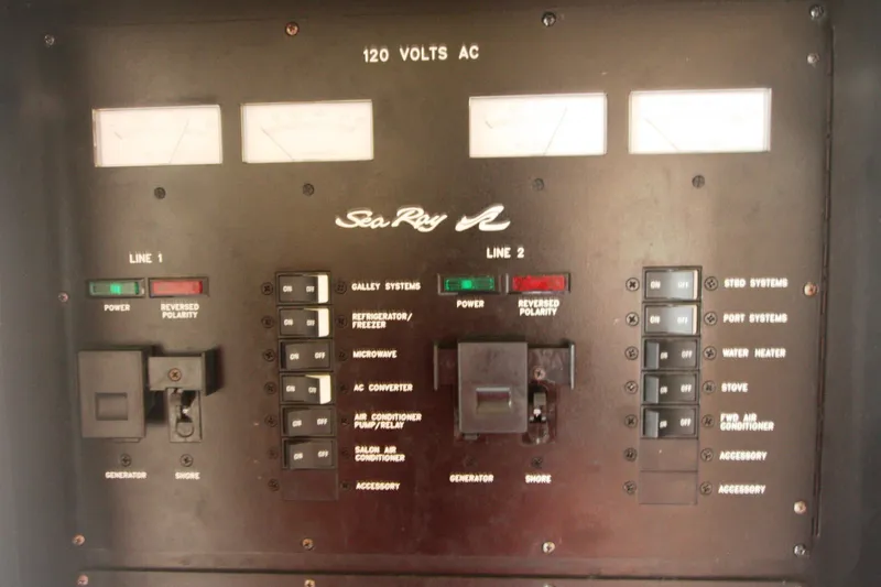 Slide: The Image of Electrical control panel of a 1999 Sea Ray 380 Sundancer boat, showing switches and indicators. - 70