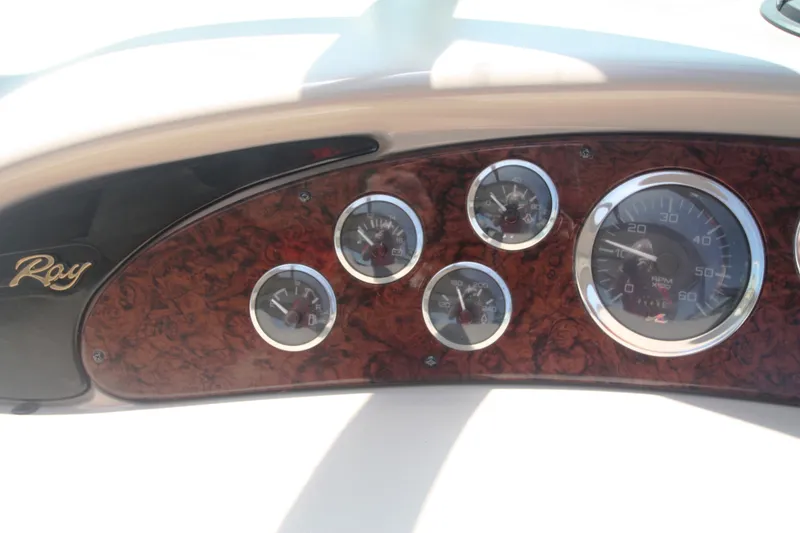 Slide: The Image of Dashboard of a 1999 Sea Ray 380 Sundancer with wood paneling and gauges. - 24
