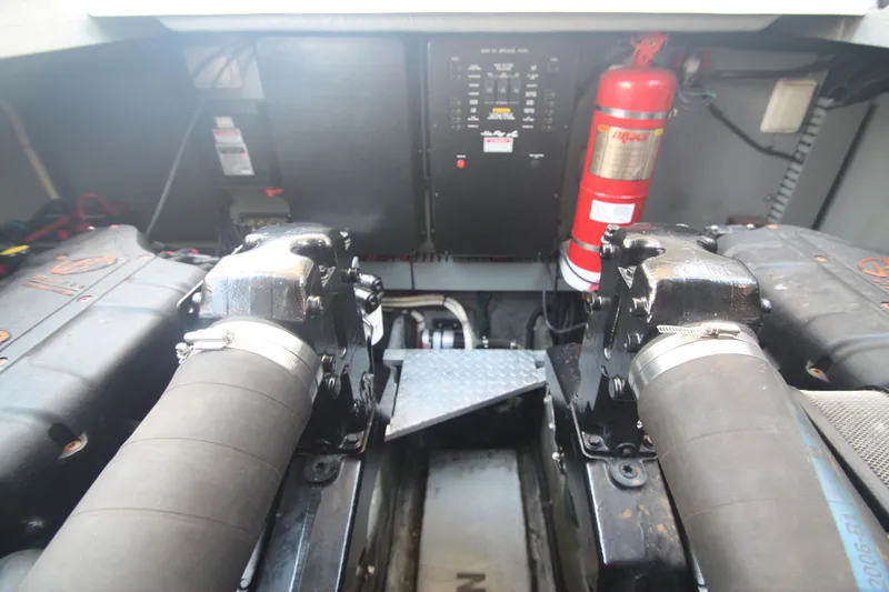 Slide: The Image of Engine room of a 1999 Sea Ray 380 Sundancer with visible components and fire extinguisher. - 66