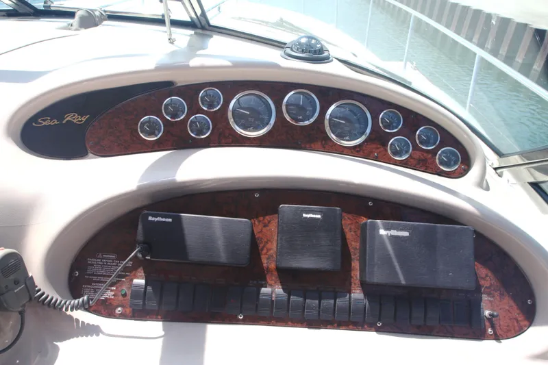 Slide: The Image of 1999 Sea Ray 380 Sundancer dashboard with gauges and Raytheon equipment. - 23