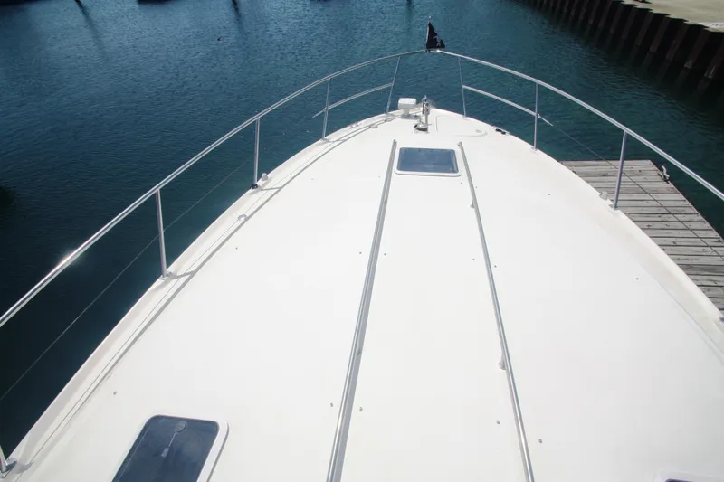 Slide: The Image of Bow view of 1999 Sea Ray 380 Sundancer yacht docked at marina. - 19