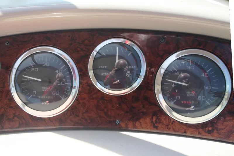 Slide: The Image of Dashboard gauges of a 1999 Sea Ray 380 Sundancer boat. - 26