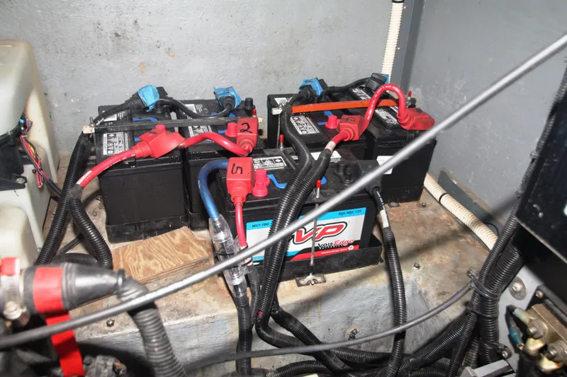 Slide: The Image of Battery compartment of a 1999 Sea Ray 380 Sundancer boat, showing multiple connected batteries. - 71