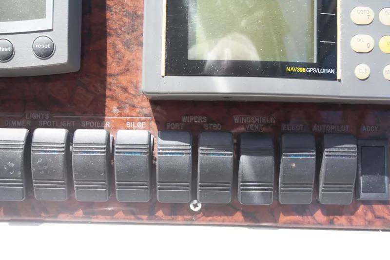 Slide: The Image of Control panel of a 1999 Sea Ray 380 Sundancer boat with labeled switches. - 34