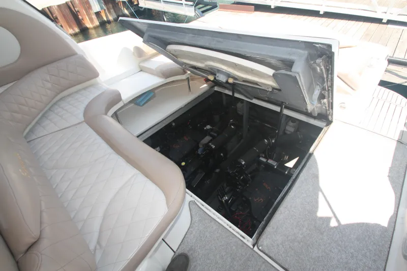 Slide: The Image of 1999 Sea Ray 380 Sundancer engine compartment with open hatch and seating area. - 61