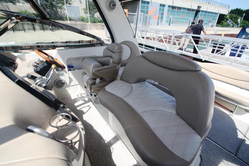 Slide: The Image of 1999 Sea Ray 380 Sundancer cockpit with luxurious seating and modern controls. - 21