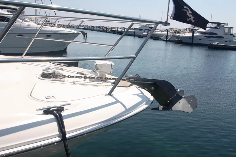 Slide: The Image of 1999 Sea Ray 380 Sundancer yacht anchored in marina, featuring bow and anchor. - 77