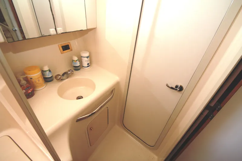 Slide: The Image of Bathroom interior of 1999 Sea Ray 380 Sundancer yacht, featuring sink and toiletries. - 60