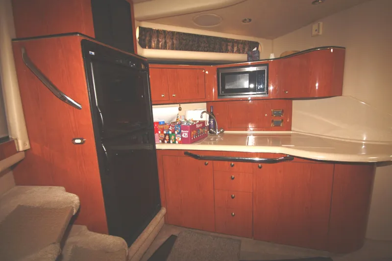 Slide: The Image of Interior of 1999 Sea Ray 380 Sundancer yacht kitchen with wood cabinetry and modern appliances. - 48