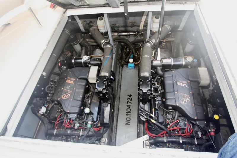 Slide: The Image of Engine compartment of a 1999 Sea Ray 380 Sundancer boat, showcasing dual V8 engines. - 62