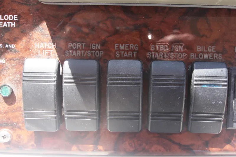 Slide: The Image of Control panel of a 1999 Sea Ray 380 Sundancer boat with labeled switches. - 31