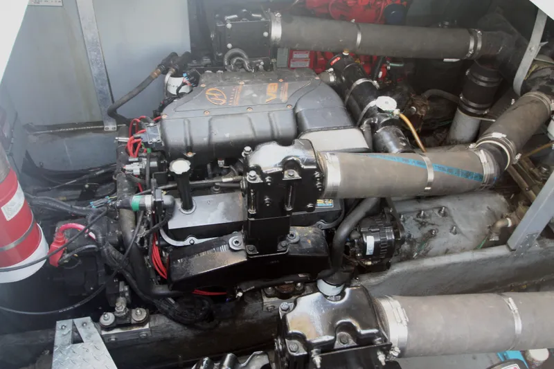 Slide: The Image of Engine compartment of a 1999 Sea Ray 380 Sundancer boat, showcasing mechanical components. - 64