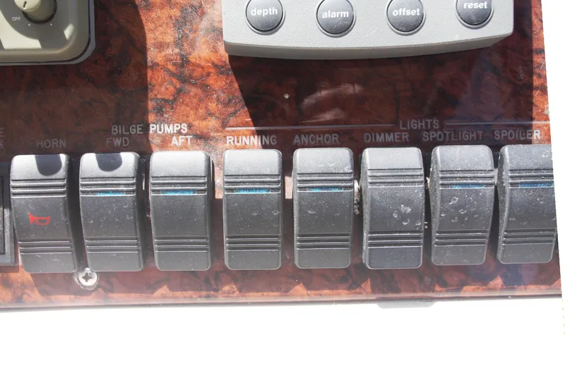 Slide: The Image of Control panel of a 1999 Sea Ray 380 Sundancer boat with labeled switches. - 33
