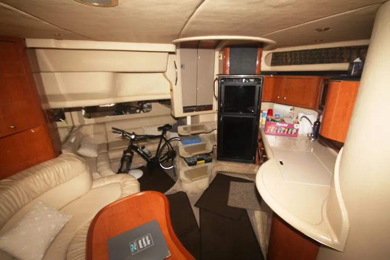 Slide: The Image of Interior of 1999 Sea Ray 380 Sundancer yacht with kitchen and seating area. - 46