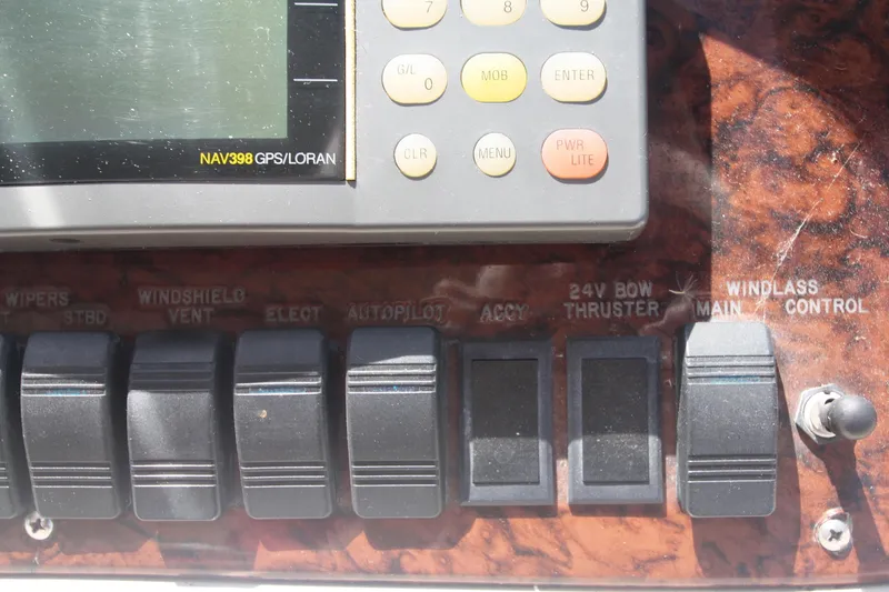 Slide: The Image of Control panel of a 1999 Sea Ray 380 Sundancer with GPS and switches. - 32