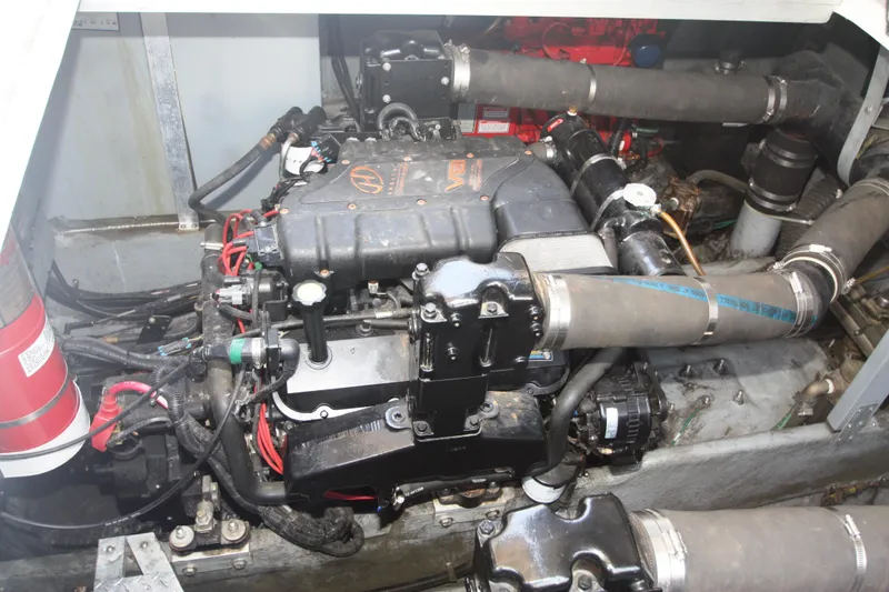 Slide: The Image of Engine compartment of a 1999 Sea Ray 380 Sundancer boat, showcasing mechanical components. - 63
