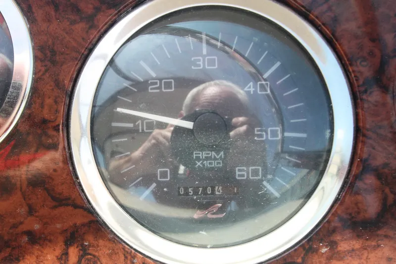 Slide: The Image of Close-up of a 1999 Sea Ray 380 Sundancer RPM gauge, showing 1070.4 hours. - 30