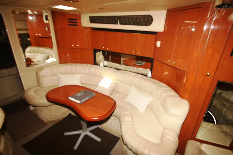 Slide: The Image of Luxurious interior of 1999 Sea Ray 380 Sundancer yacht with plush seating and wooden cabinetry. - 47