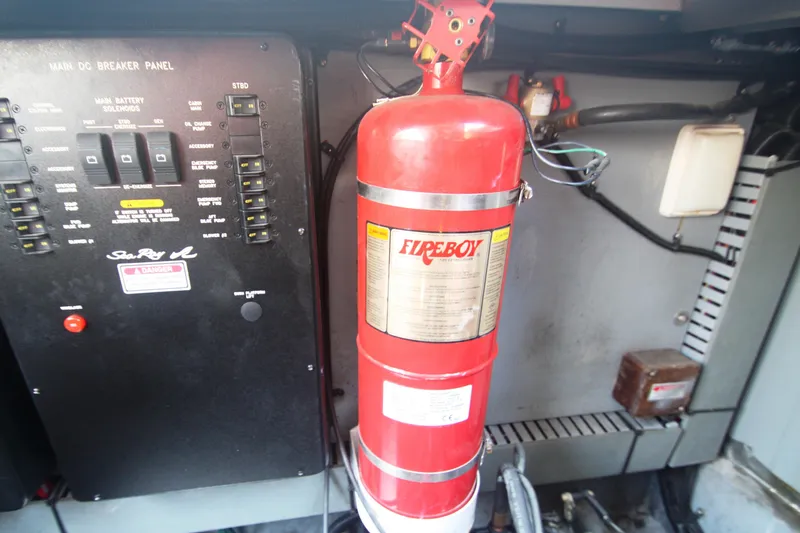 Slide: The Image of Fire extinguisher and breaker panel on 1999 Sea Ray 380 Sundancer boat. - 67