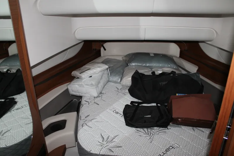 Slide: The Image of Interior cabin of 2027 Tiara Yachts 46 LS with bedding and bags. - 10