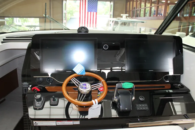 Slide: The Image of Helm of 2027 Tiara Yachts 46 LS with dual Garmin displays and wooden steering wheel. - 8