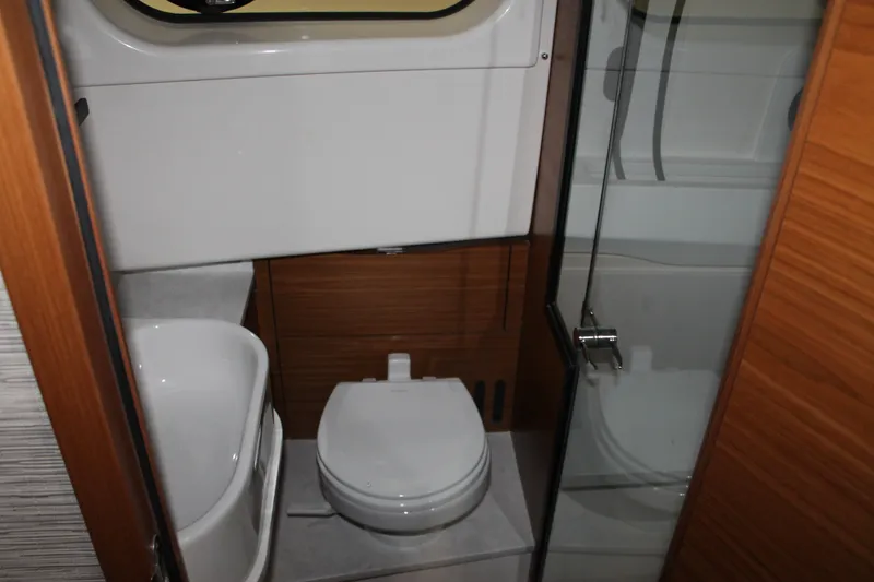 Slide: The Image of Modern bathroom in 2027 Tiara Yachts 46 LS, featuring sleek design and glass shower door. - 12