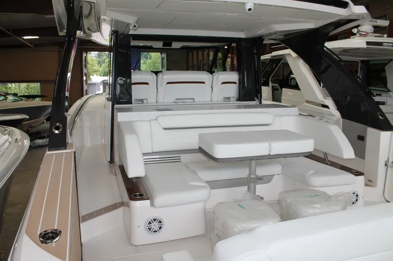 Slide: The Image of 2027 Tiara Yachts 46 LS interior with white seating and table in showroom. - 3