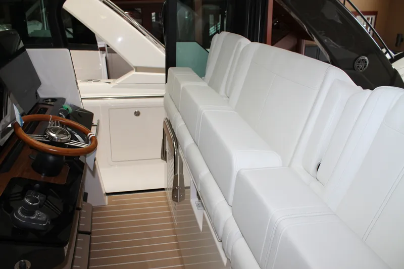 Slide: The Image of Interior of 2027 Tiara Yachts 46 LS, featuring white seating and sleek helm design. - 7