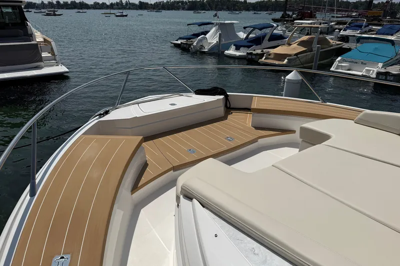Slide: The Image of 2027 Tiara Yachts EX 54 bow with teak decking at marina. - 43
