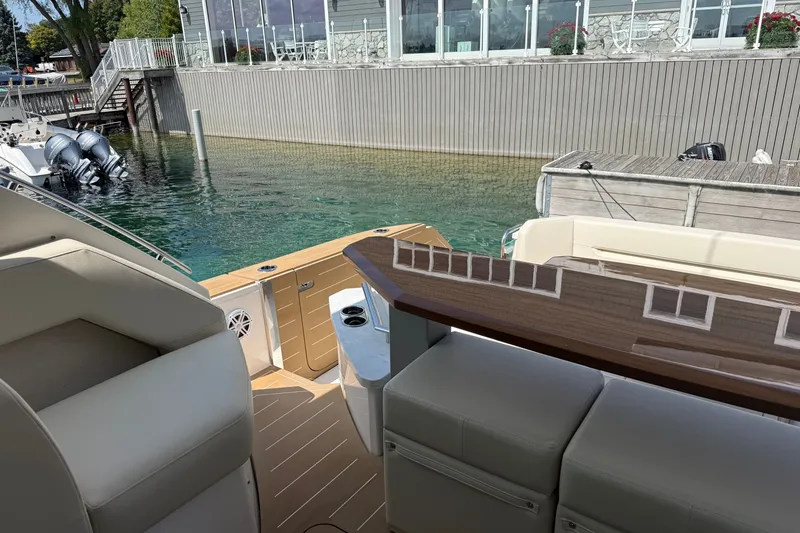 Slide: The Image of Luxury Tiara Yachts EX 54, 2027 model, docked with elegant interior seating. - 52