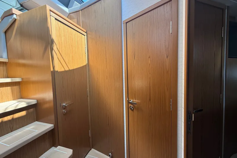 Slide: The Image of Interior of 2027 Tiara Yachts EX 54, featuring wooden doors and staircase. - 33