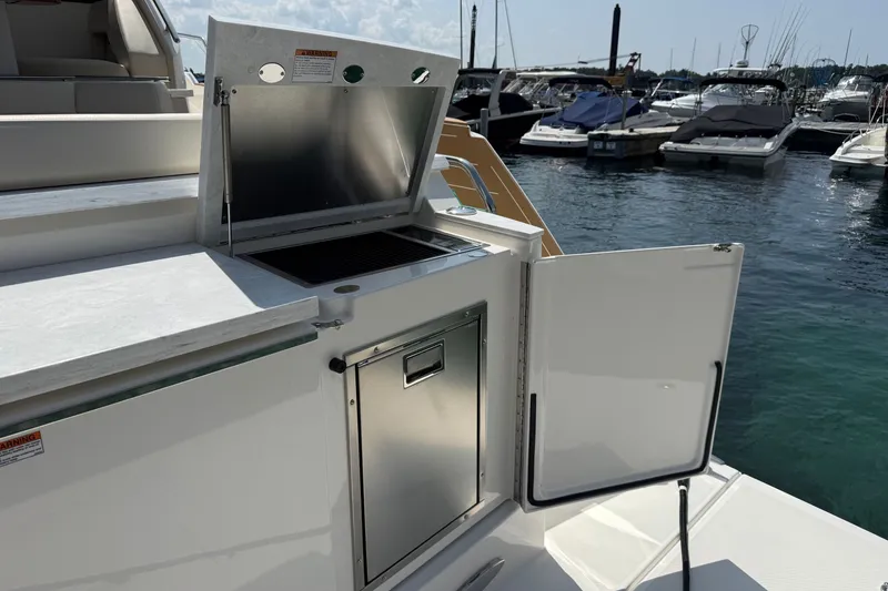 Slide: The Image of Outdoor kitchen on 2027 Tiara Yachts EX 54, docked at marina. - 59
