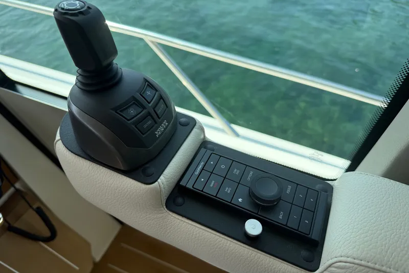 Slide: The Image of Control panel of 2027 Tiara Yachts EX 54, featuring joystick and navigation controls. - 20