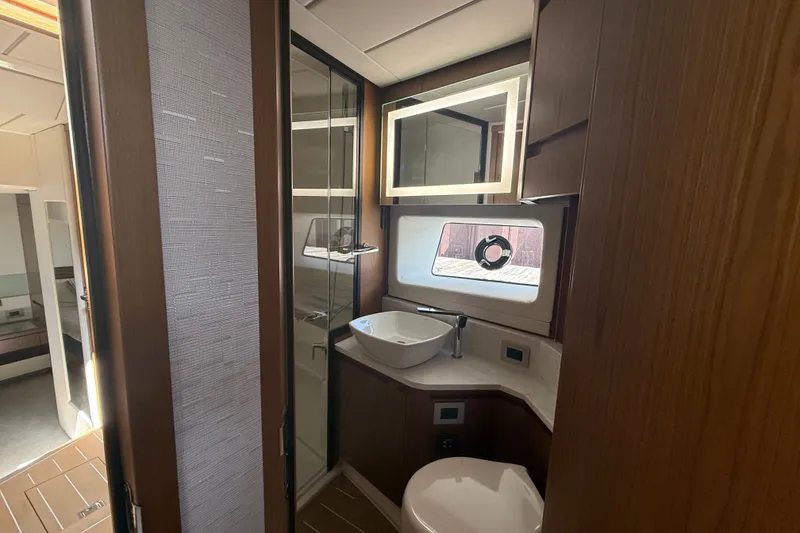 Slide: The Image of Luxurious bathroom interior of 2027 Tiara Yachts EX 54, featuring modern fixtures and elegant wood finishes. - 30